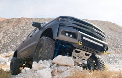 Black Diamond Truck on rocks passenger side